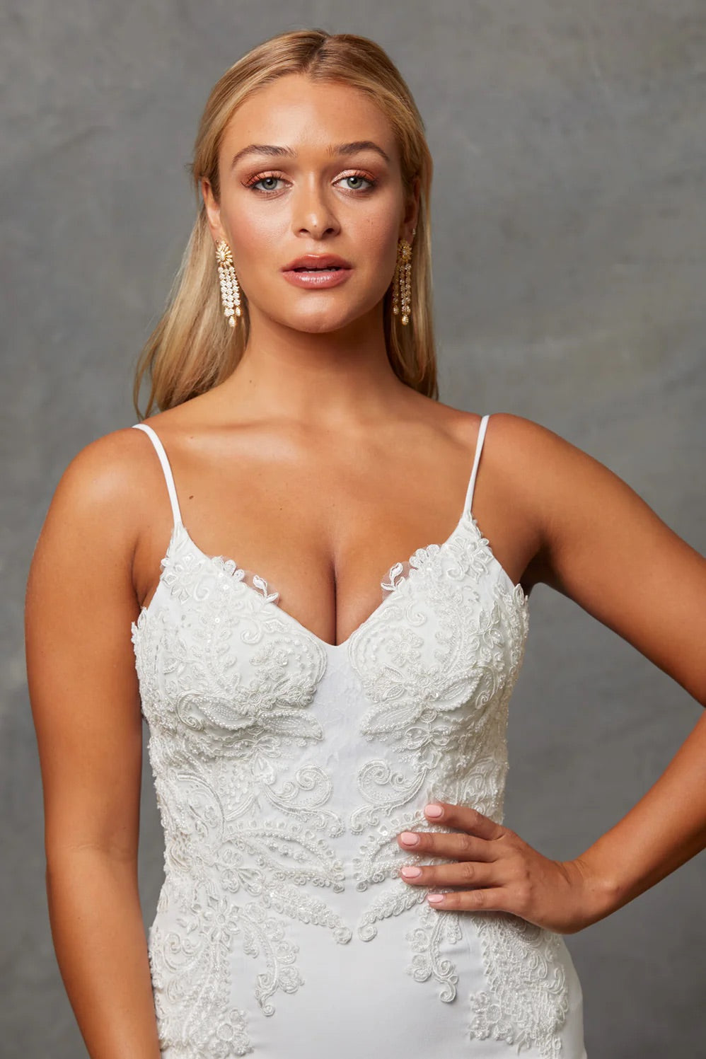 A portrait close up of a bride wearing a Crepe Fit and Flare Wedding Dress