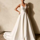 Textured Mikado A-line wedding dress with deep V neckline, structured bodice, and flowing chapel train.
