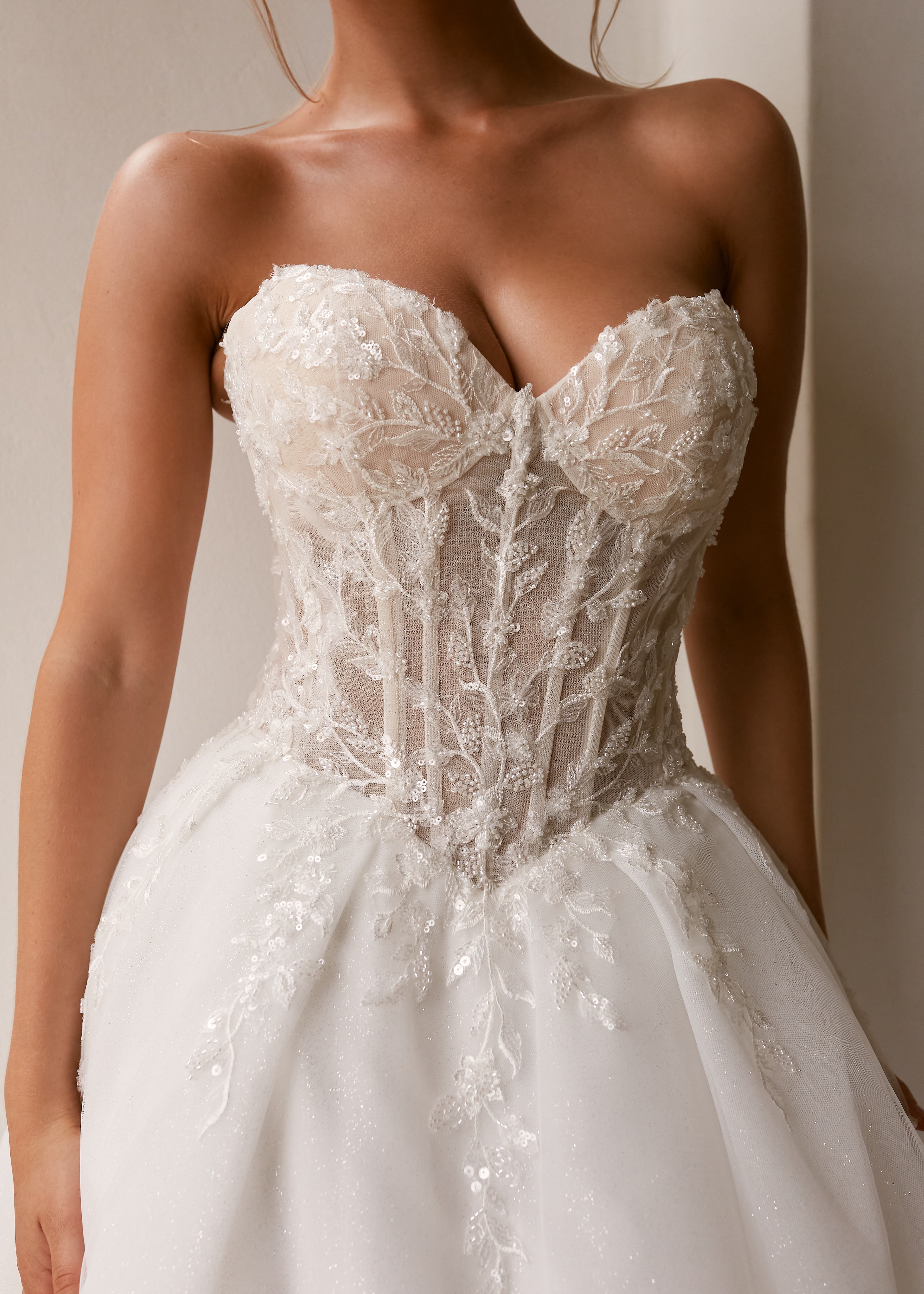 Bodice detail shot of a woman wearing a Strapless Ball Gown Wedding Dress