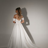 Soulmate off-shoulder wedding dress back view with button detail and full A-line skirt with train.