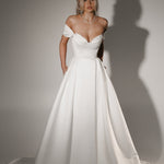 Soulmate off-shoulder wedding dress with draped sweetheart bodice and full A-line skirt.