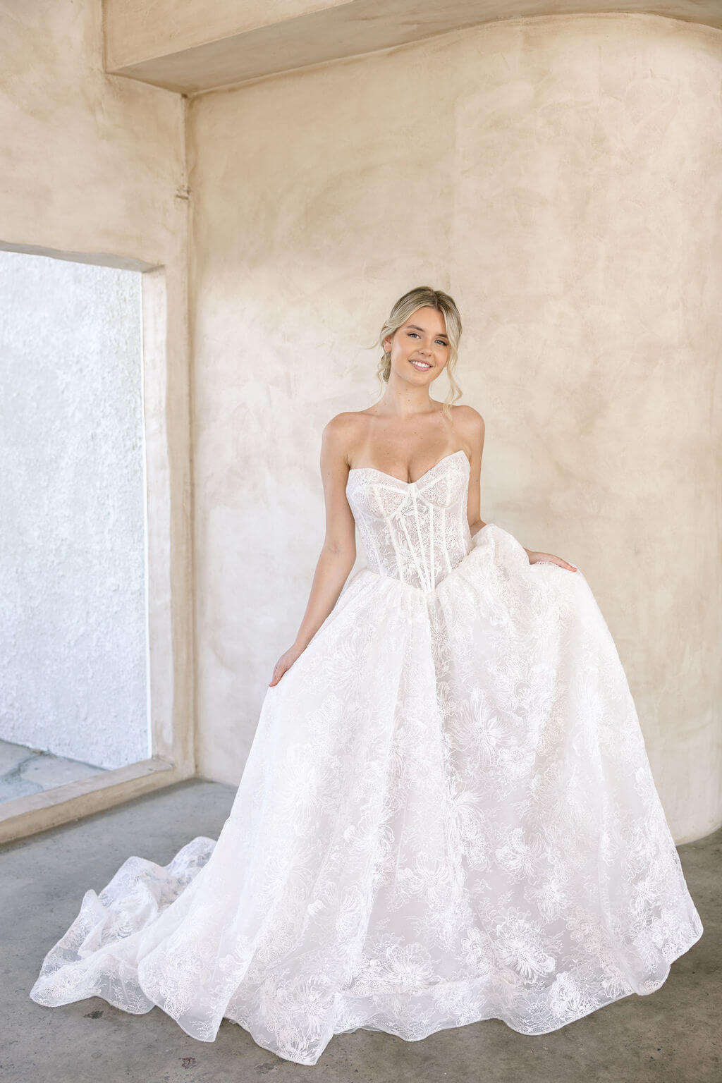 Wintor embroidered lace ballgown wedding dress with strapless sweetheart basque bodice and full lace skirt.
