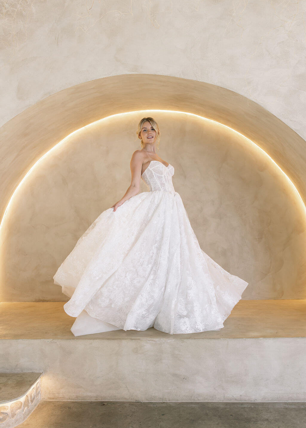 Wintor embroidered lace ballgown wedding dress with strapless sweetheart basque bodice and full lace skirt.
