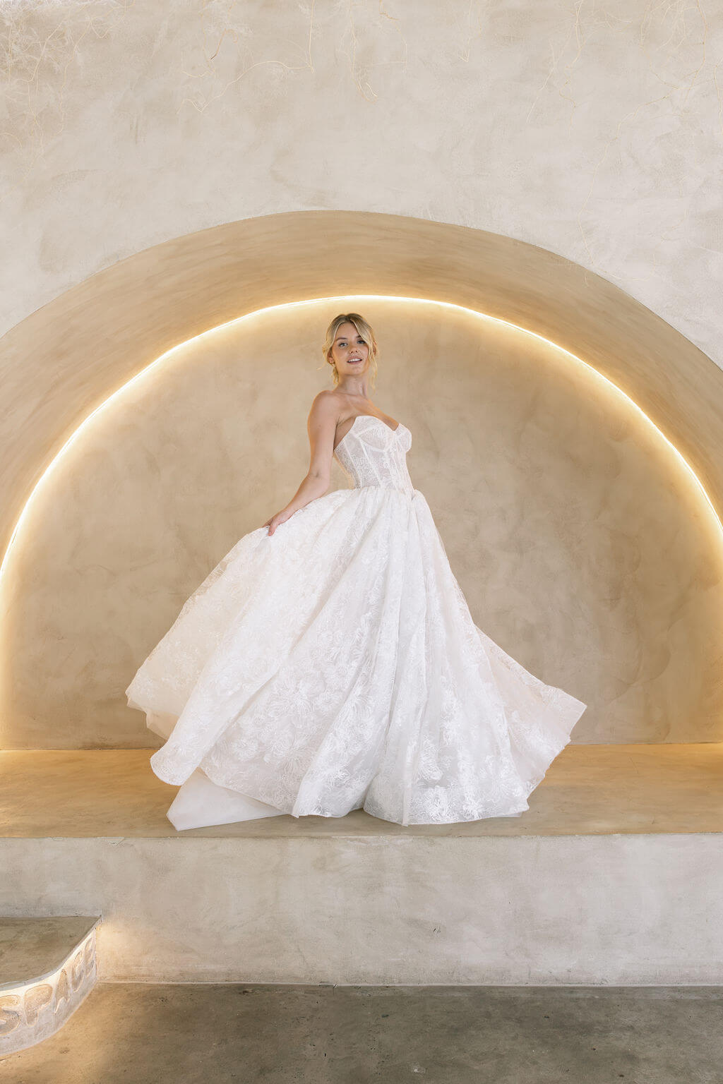 Wintor embroidered lace ballgown wedding dress with strapless sweetheart basque bodice and full lace skirt.
