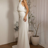 Elegant minimalist wedding dress with halter bodice and soft flowing train