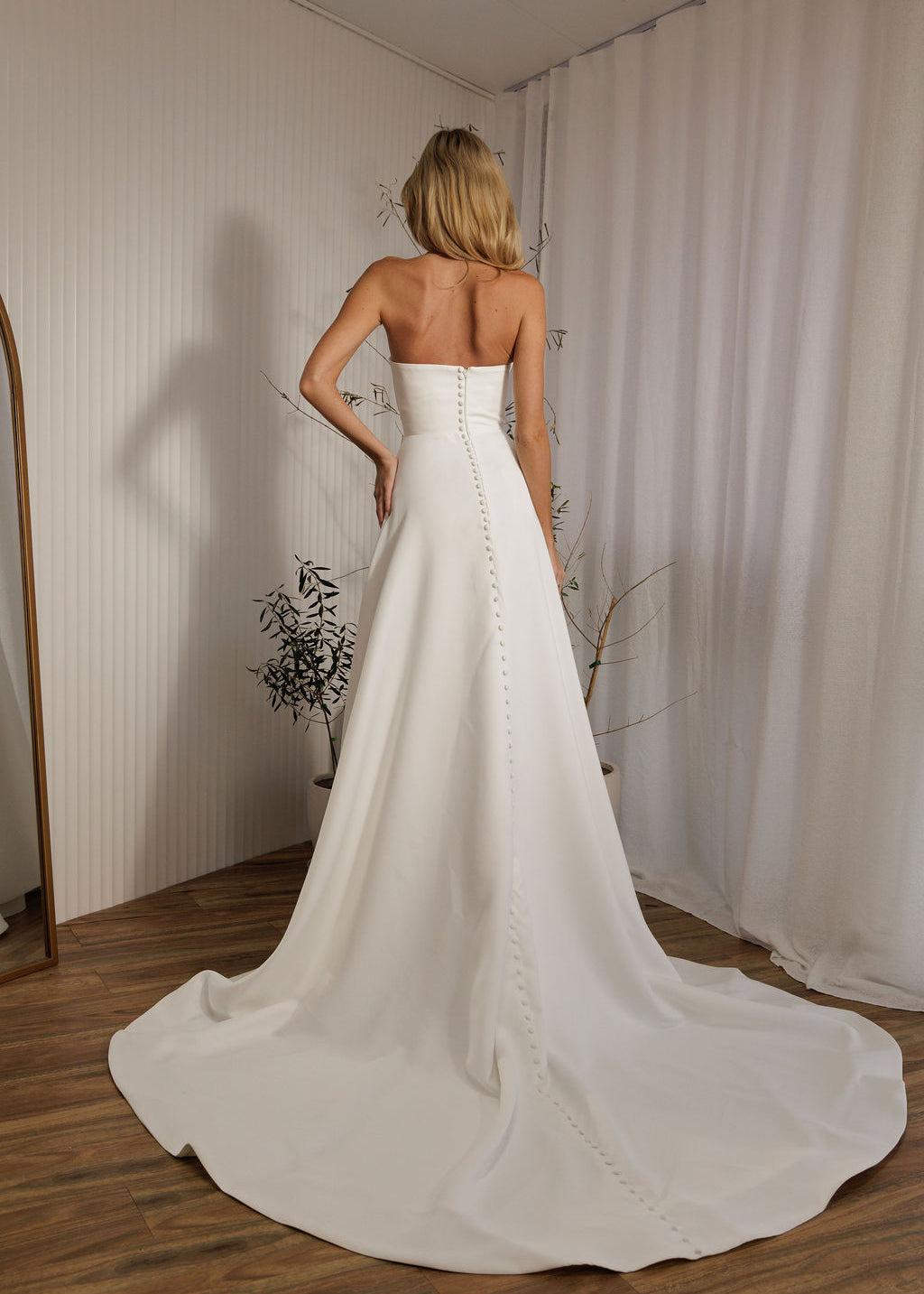 Austin minimalist wedding dress back view with button detail and flowing train