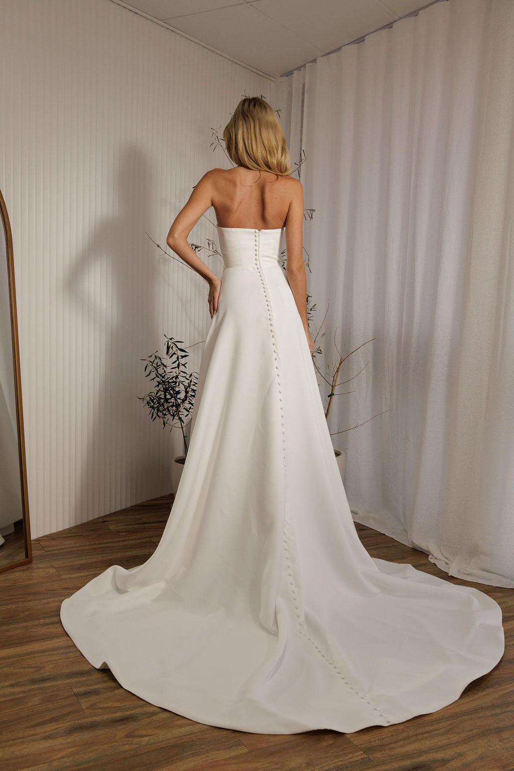 Austin minimalist wedding dress back view with button detail and flowing train