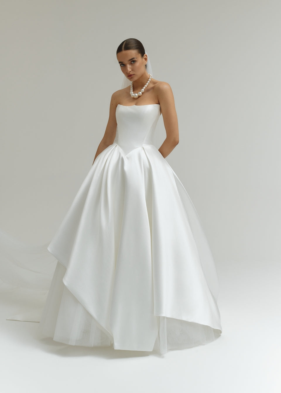 Strapless Mikado ballgown wedding dress on a model against a plain background