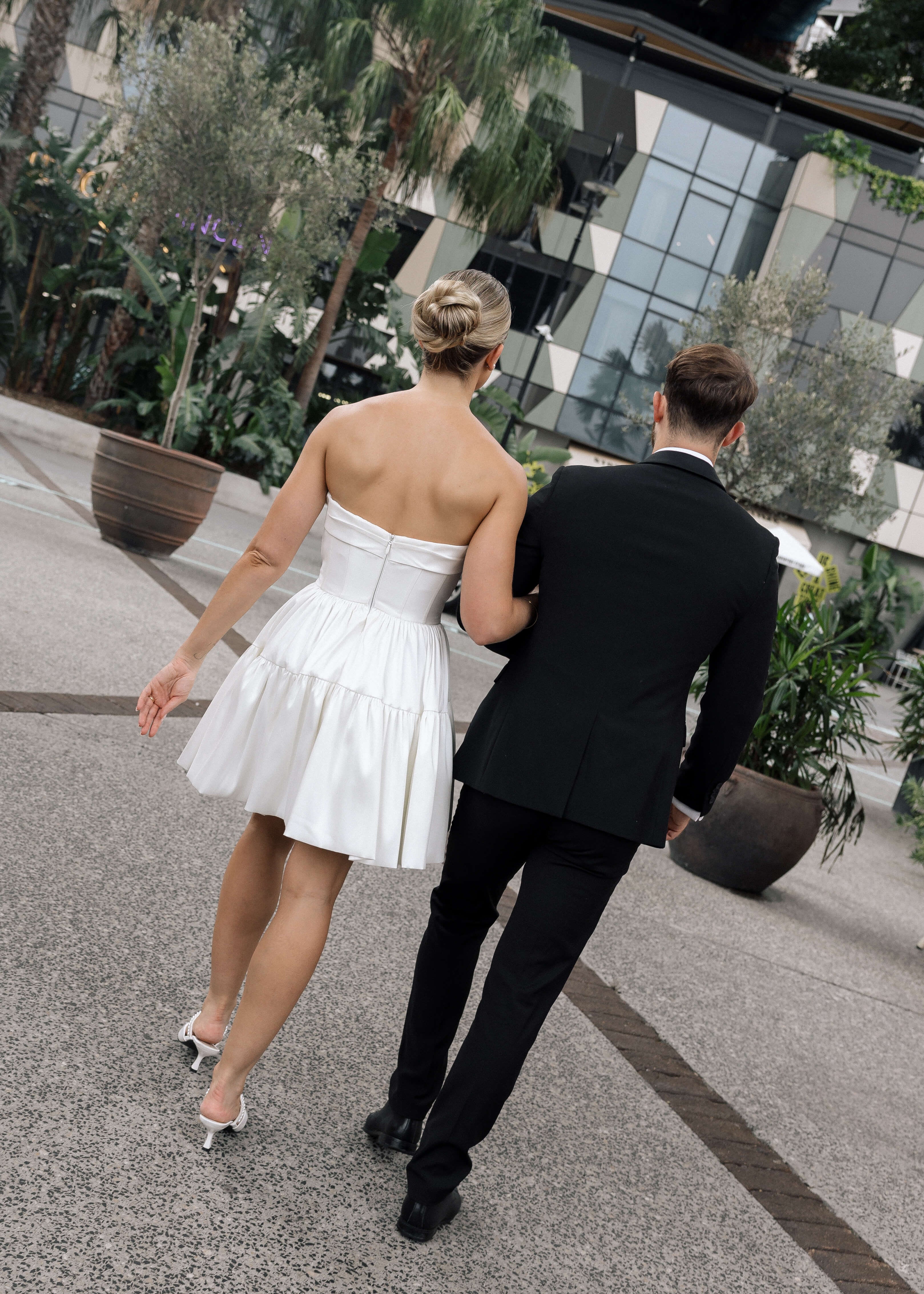 Bardot wedding dress in Brisbane featuring strapless neckline and playful mini silhouette