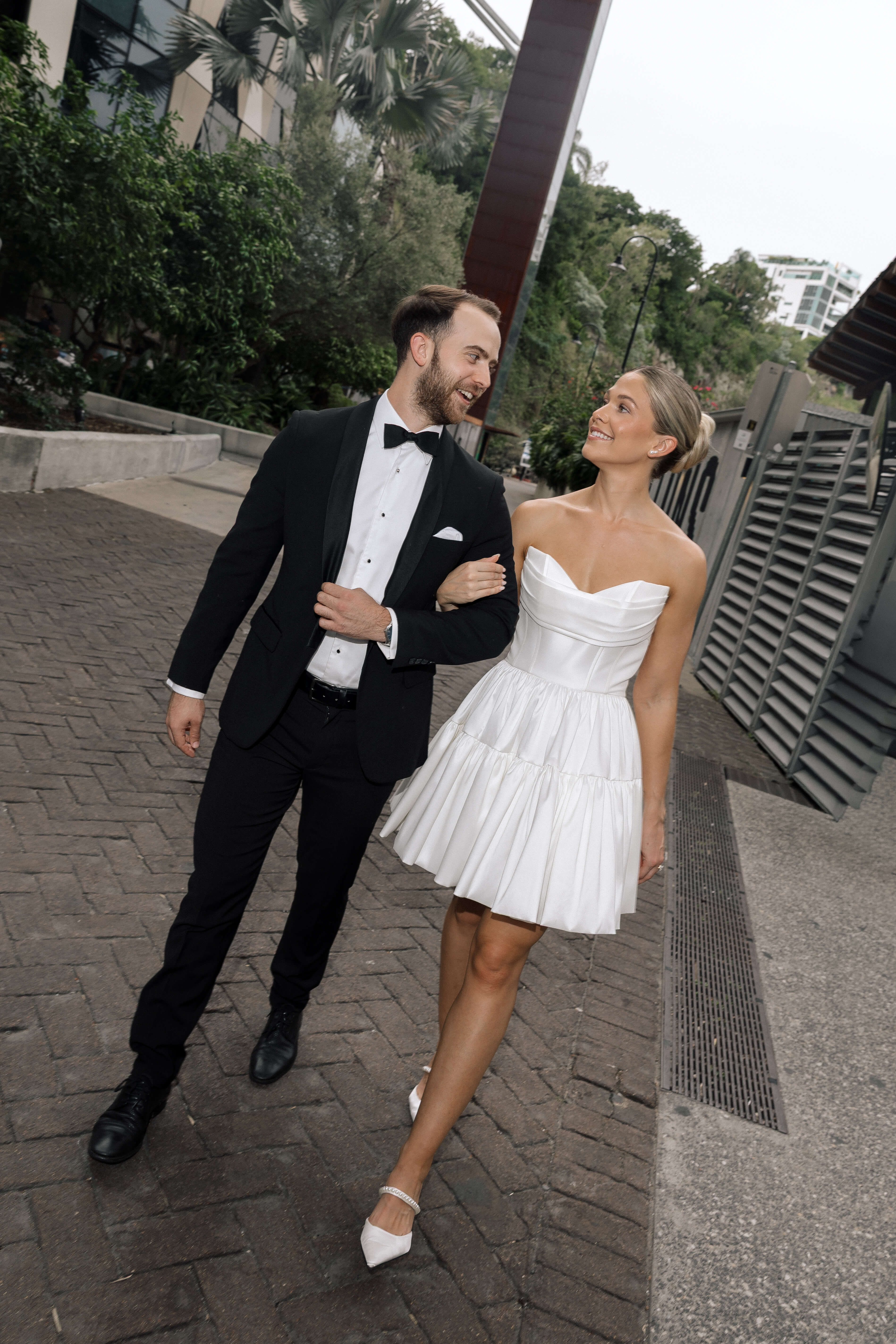 Bardot wedding dress in Brisbane featuring strapless neckline and playful mini silhouette