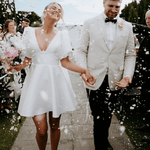 Belle Mini wedding dress in at wedding ceremony featuring short A-line silhouette and puff sleeves