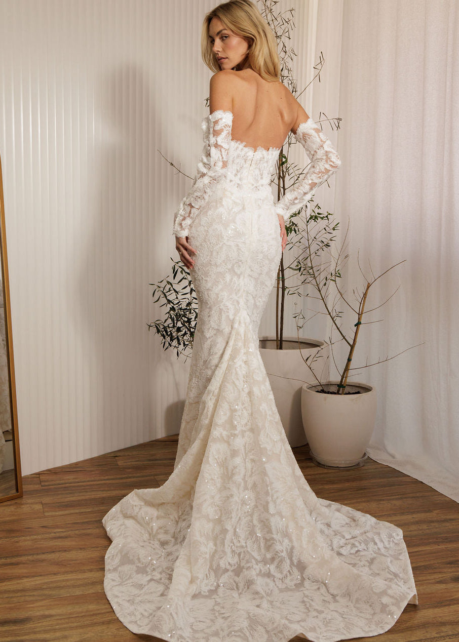 Ivory lace fit-and-flare wedding dress with off-the-shoulder sleeves and lace train back view