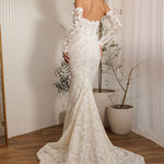 Ivory lace fit-and-flare delicate beaded lace statement gown wedding dress with off-the-shoulder sleeves and lace train back view
