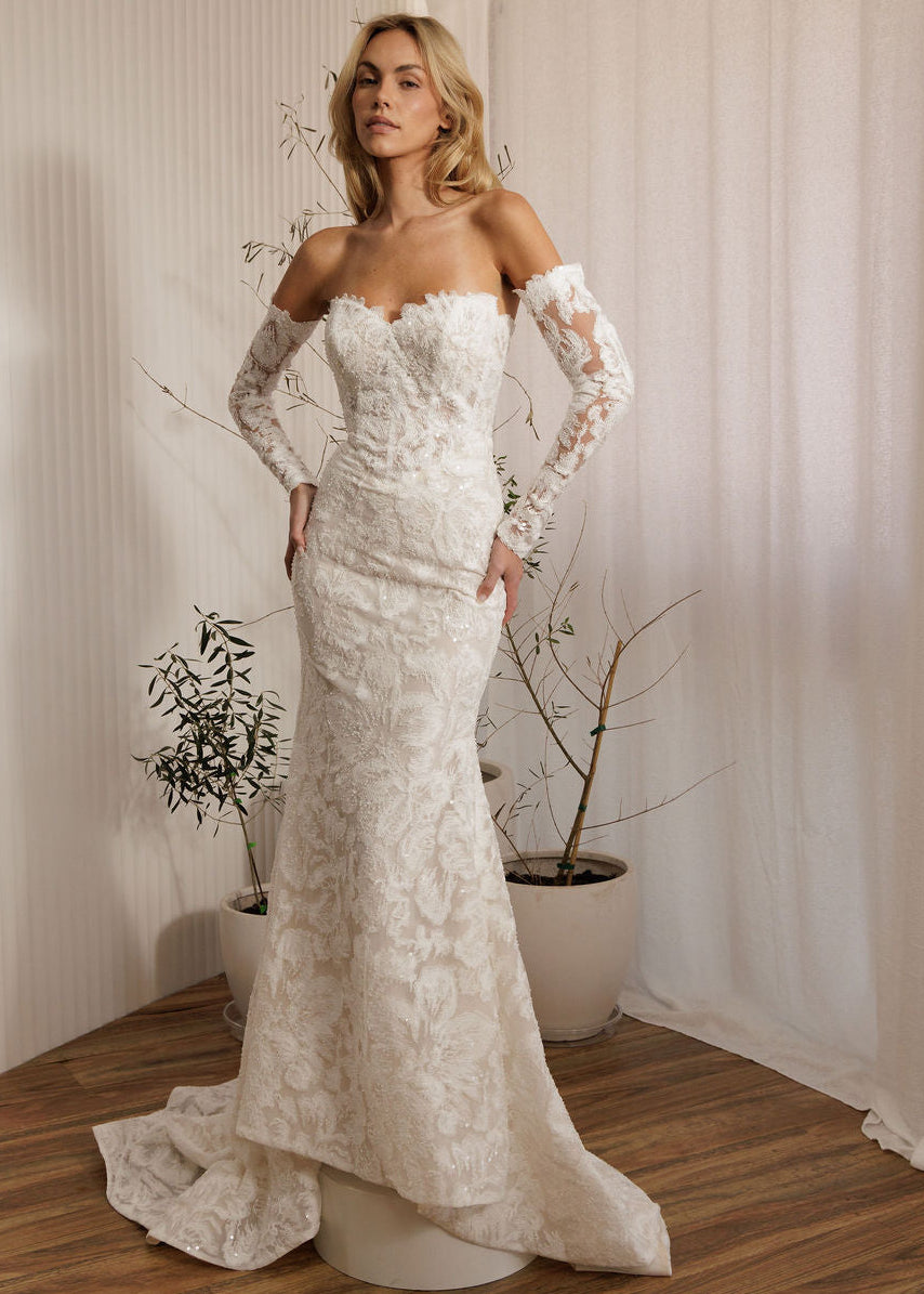 Ivory lace fit-and-flare wedding dress with sweetheart neckline and long lace sleeves