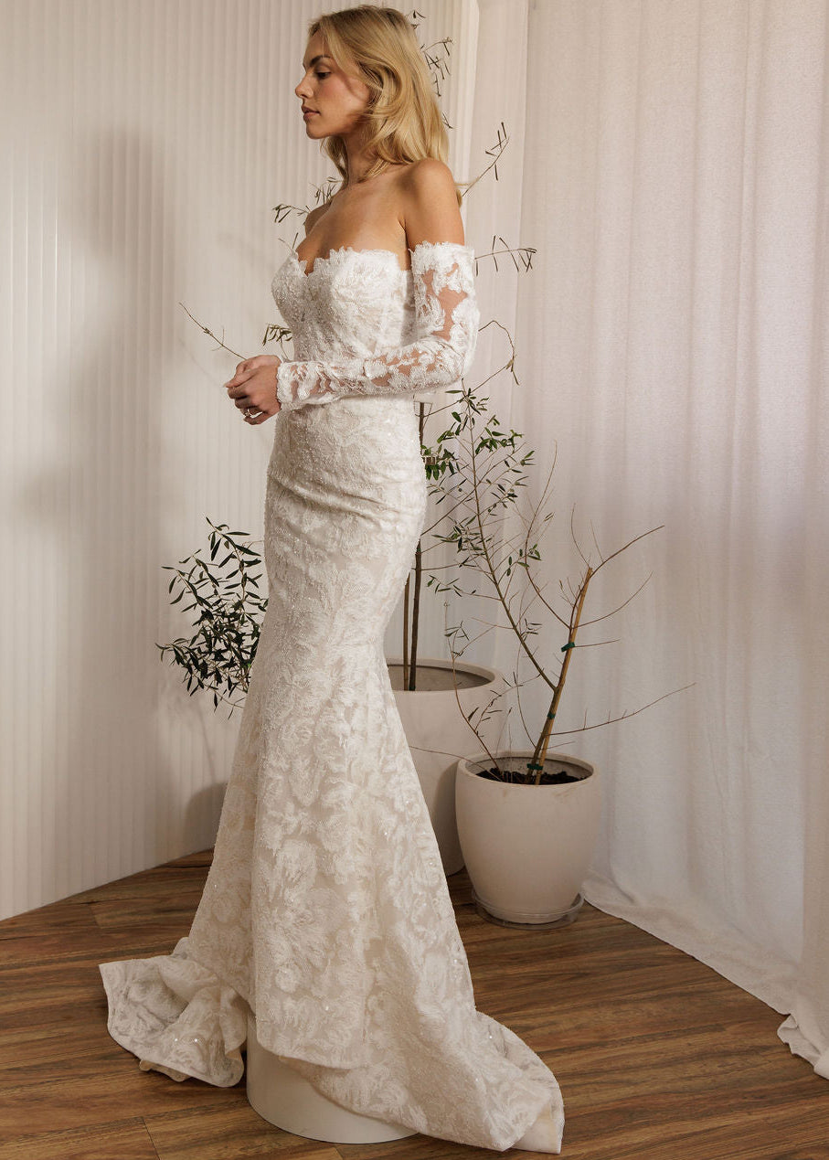 Ivory lace fit-and-flare wedding dress with sweetheart neckline and off-the-shoulder lace sleeves side view