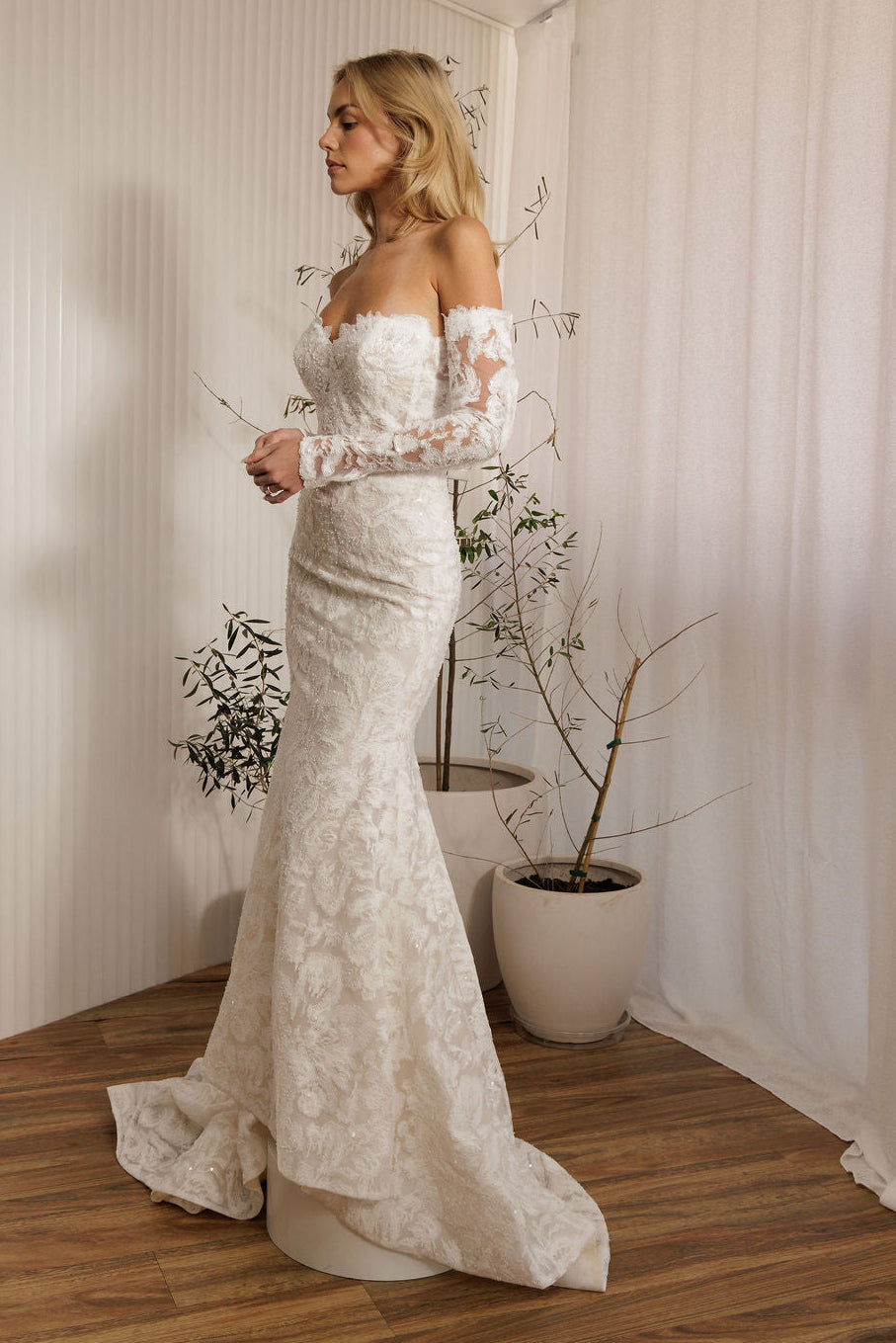 Ivory lace fit-and-flare wedding dress with sweetheart neckline and off-the-shoulder lace sleeves side view
