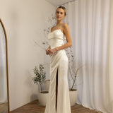 Woman in a strapless Two Piece Bridal Gown standing in a room with a neutral color scheme.