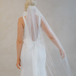Back of a bride wearing a veil and a Crepe Fit and Flare Wedding Dress