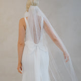 Back of a bride wearing a veil and a Crepe Fit and Flare Wedding Dress