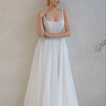 Woman wearing a Beaded A-Line Wedding Dress against a plain background