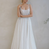 Woman wearing a Beaded A-Line Wedding Dress against a plain background