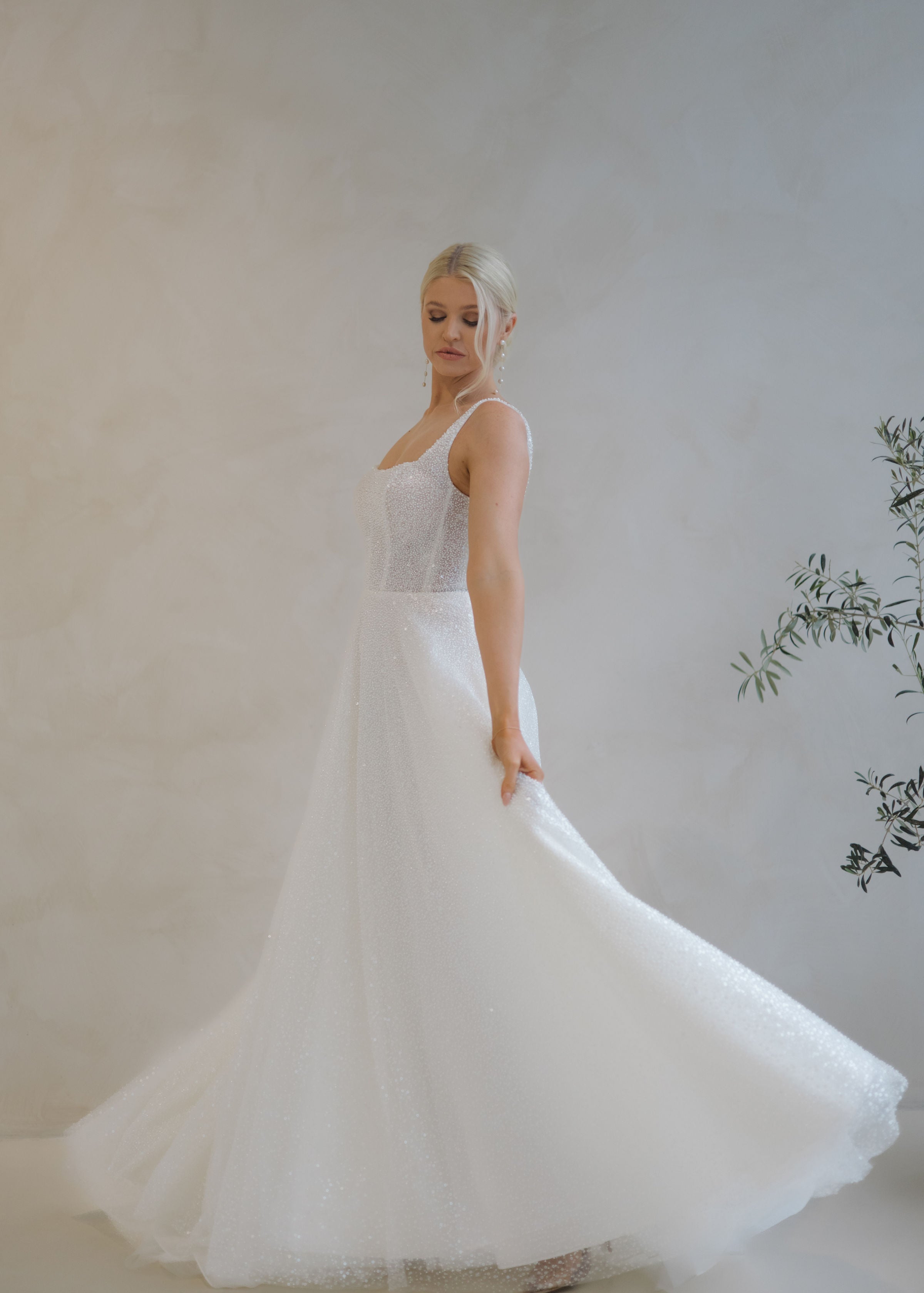 Bride spinning in a Beaded A-Line Wedding Dress