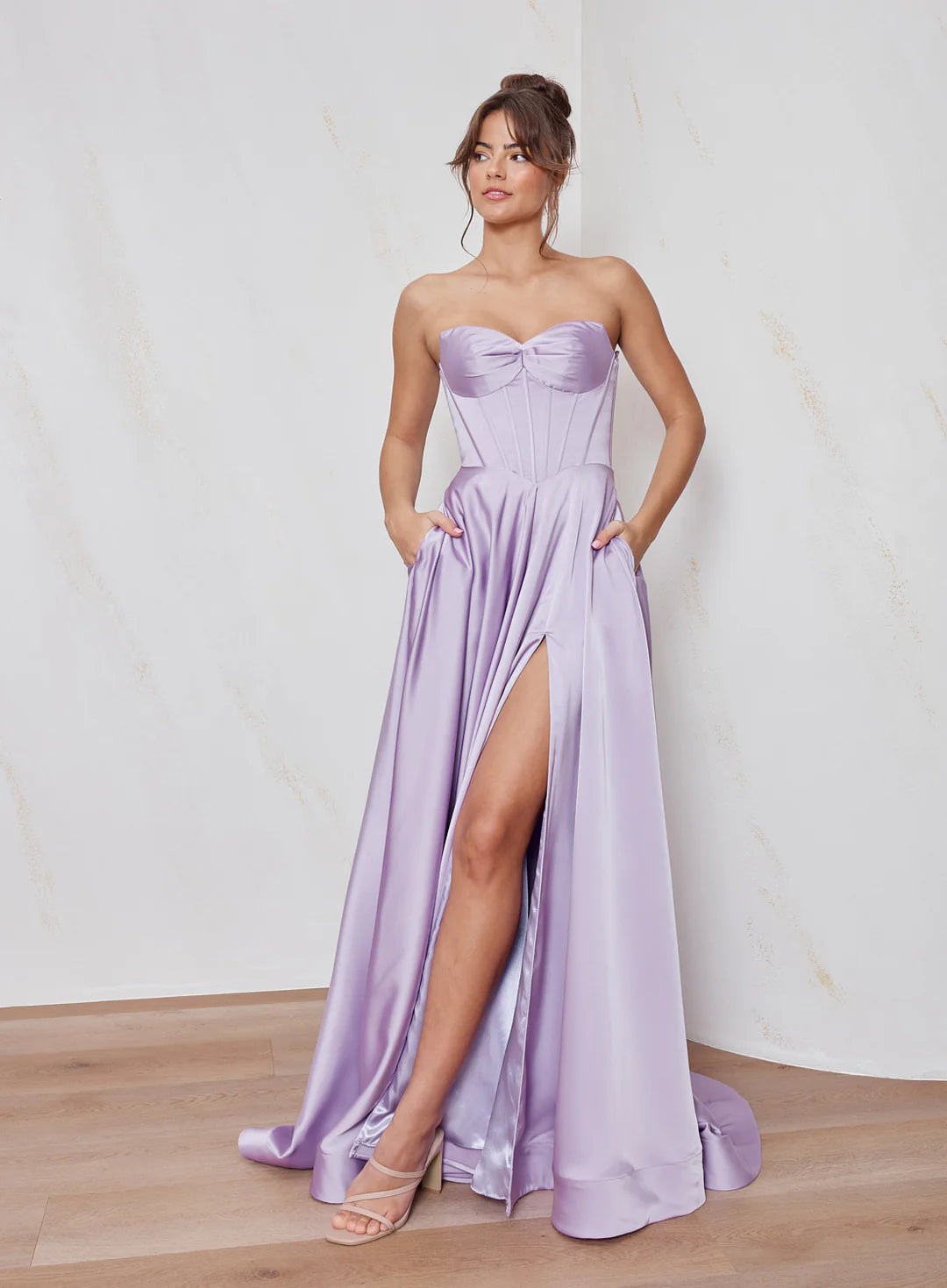 Celine satin A-line formal dress in lilac with strapless corset bodice and structured flowing skirt.