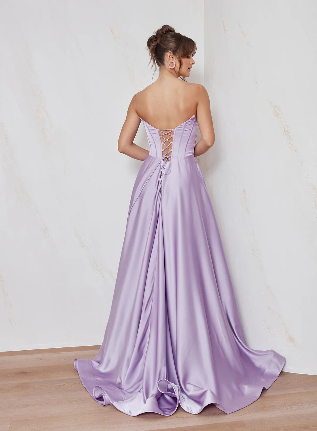 Celine satin A-line forma; dress back view with strapless corset bodice, lace-up back detail and flowing satin skirt.