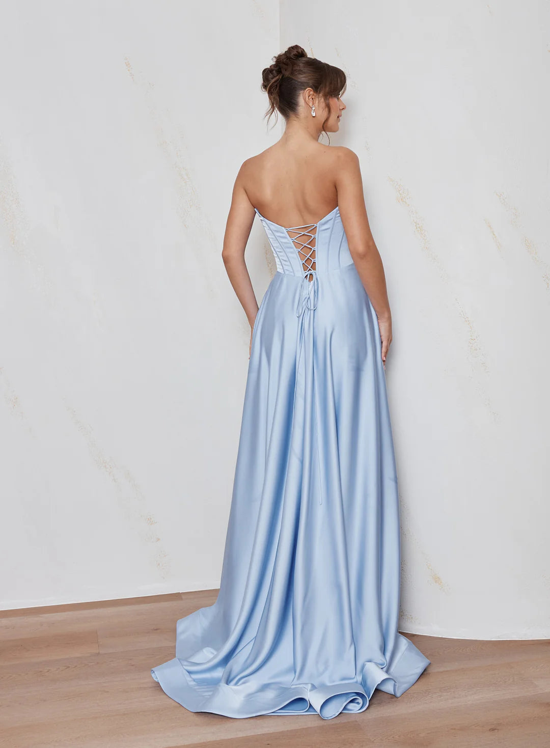 Celine satin A-line formal dress back view with strapless corset bodice, lace-up back detail and flowing satin skirt.