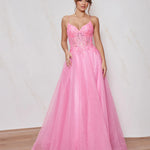 Woman wearing a pink evening gown with a white background