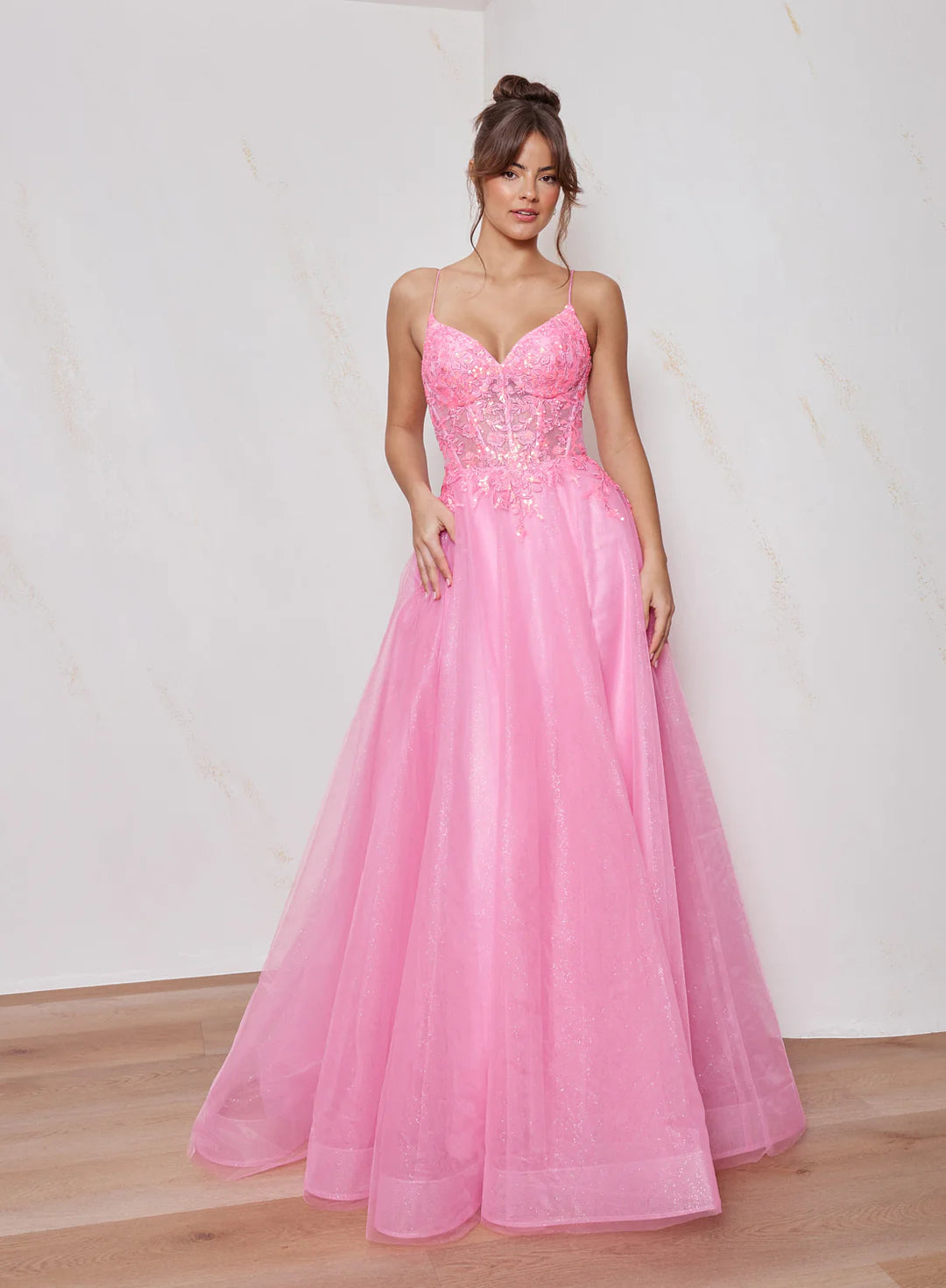 Woman wearing a pink evening gown with a white background