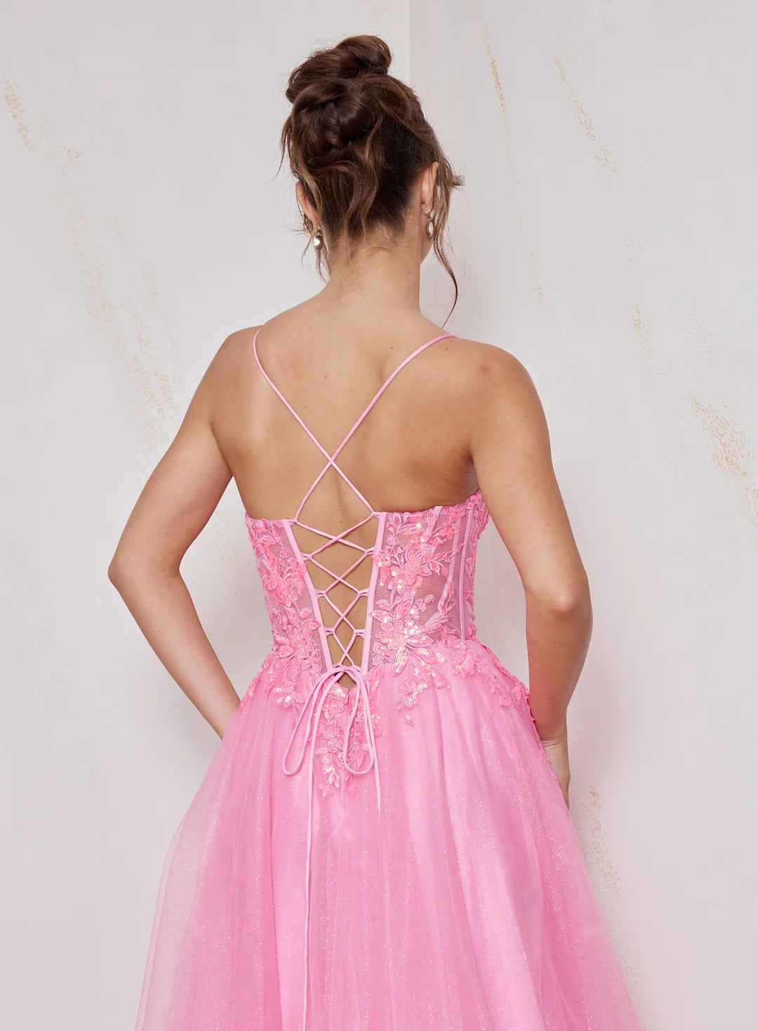 Pink dress with criss-cross back design on a light background