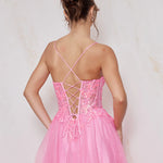 Pink dress with criss-cross back design on a light background