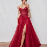 Woman wearing a red evening gown with a slit on a plain background