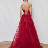 Red evening gown with intricate back design on a plain background