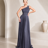 Woman wearing a one-shoulder blue gown in a minimalistic setting