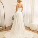 Woman in a Lace Strapless A-Line Wedding Dress standing in a room with white curtains and a wooden floor.