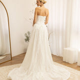 Woman in a Lace Strapless A-Line Wedding Dress standing in a room with white curtains and a wooden floor.