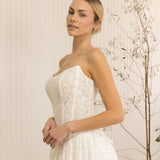 Woman wearing a Lace Strapless A-Line Wedding Dress against a neutral background