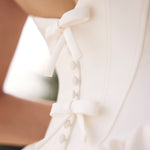 Close-up of a white blouse with ruffled details
