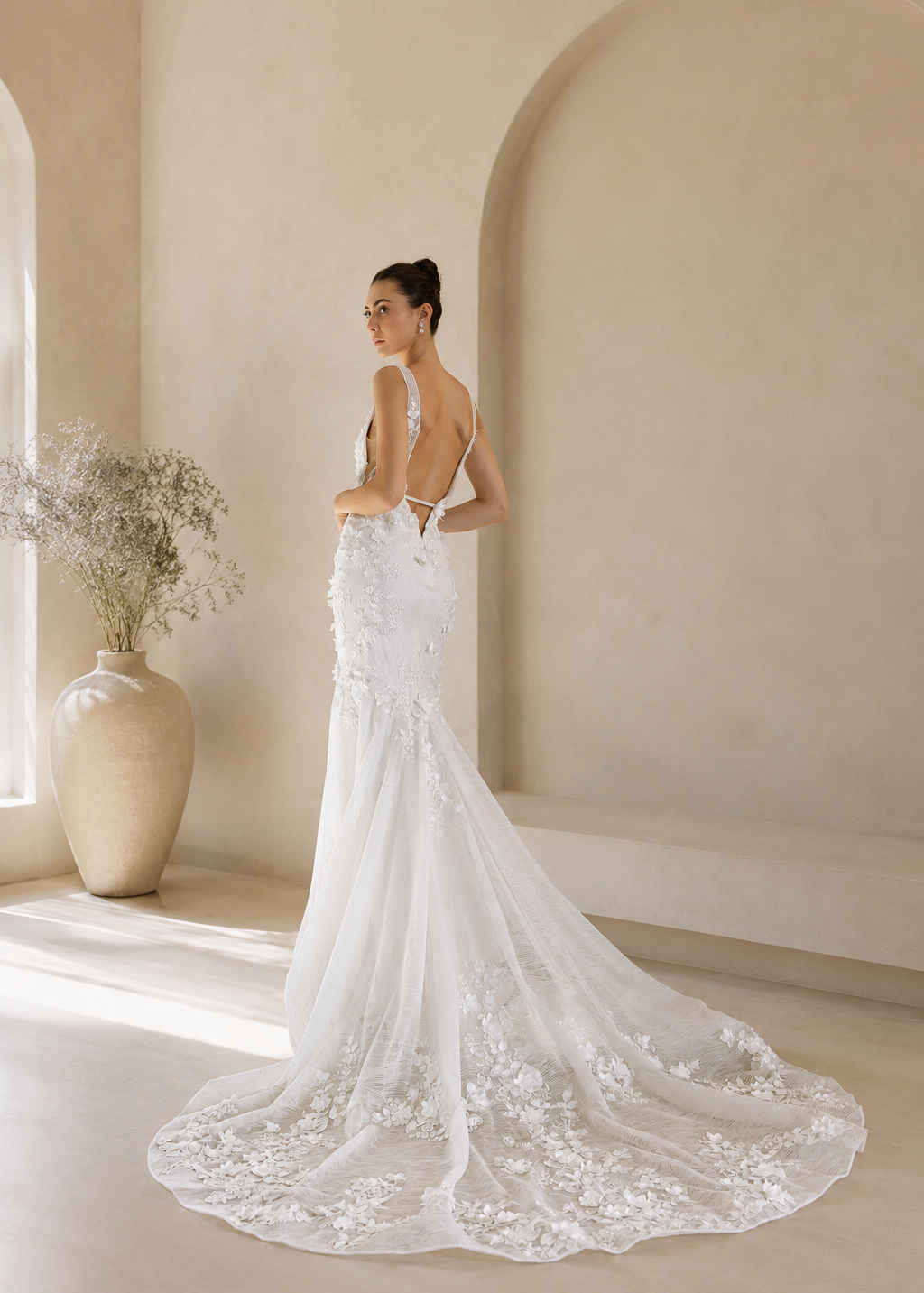 Woman in a Floral Fit and Flare Bridal Gown with a long train in a modern indoor setting