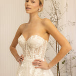 Woman wearing a white Romantic Lace Wedding Dress against a neutral background