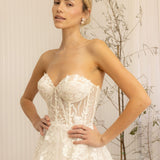 Woman wearing a white Romantic Lace Wedding Dress against a neutral background