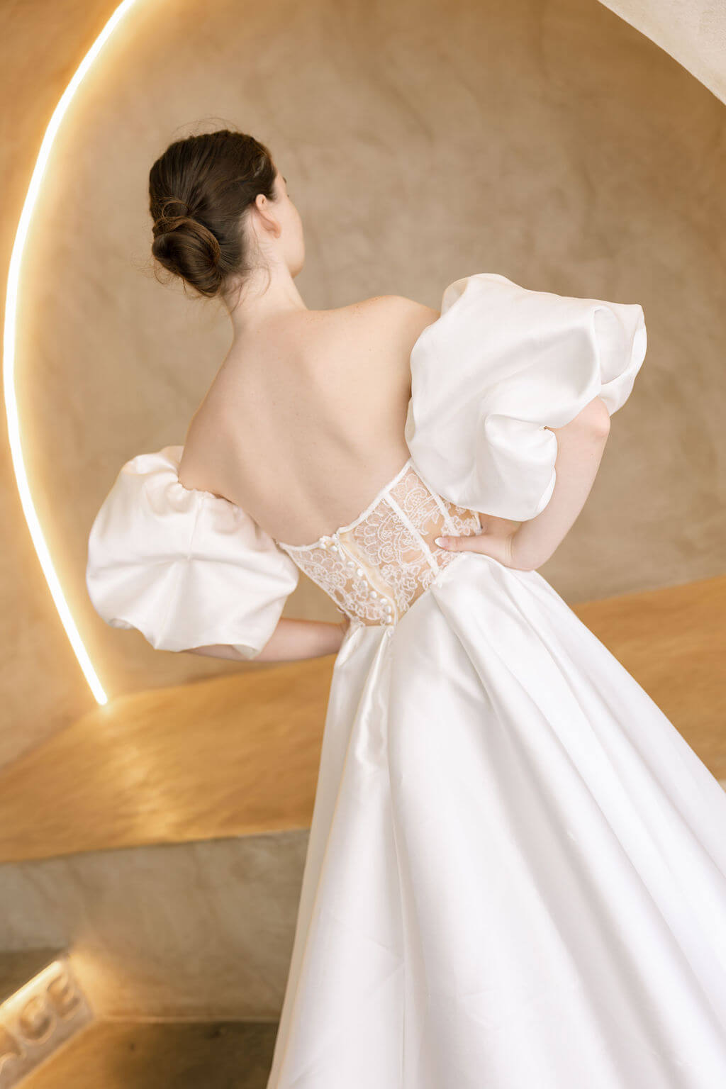 Heston wedding dress back view with lace bodice detail, puff sleeves and full satin skirt with train.
