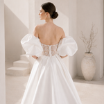 Heston wedding dress back view with lace bodice detail, puff sleeves and full satin skirt with train.