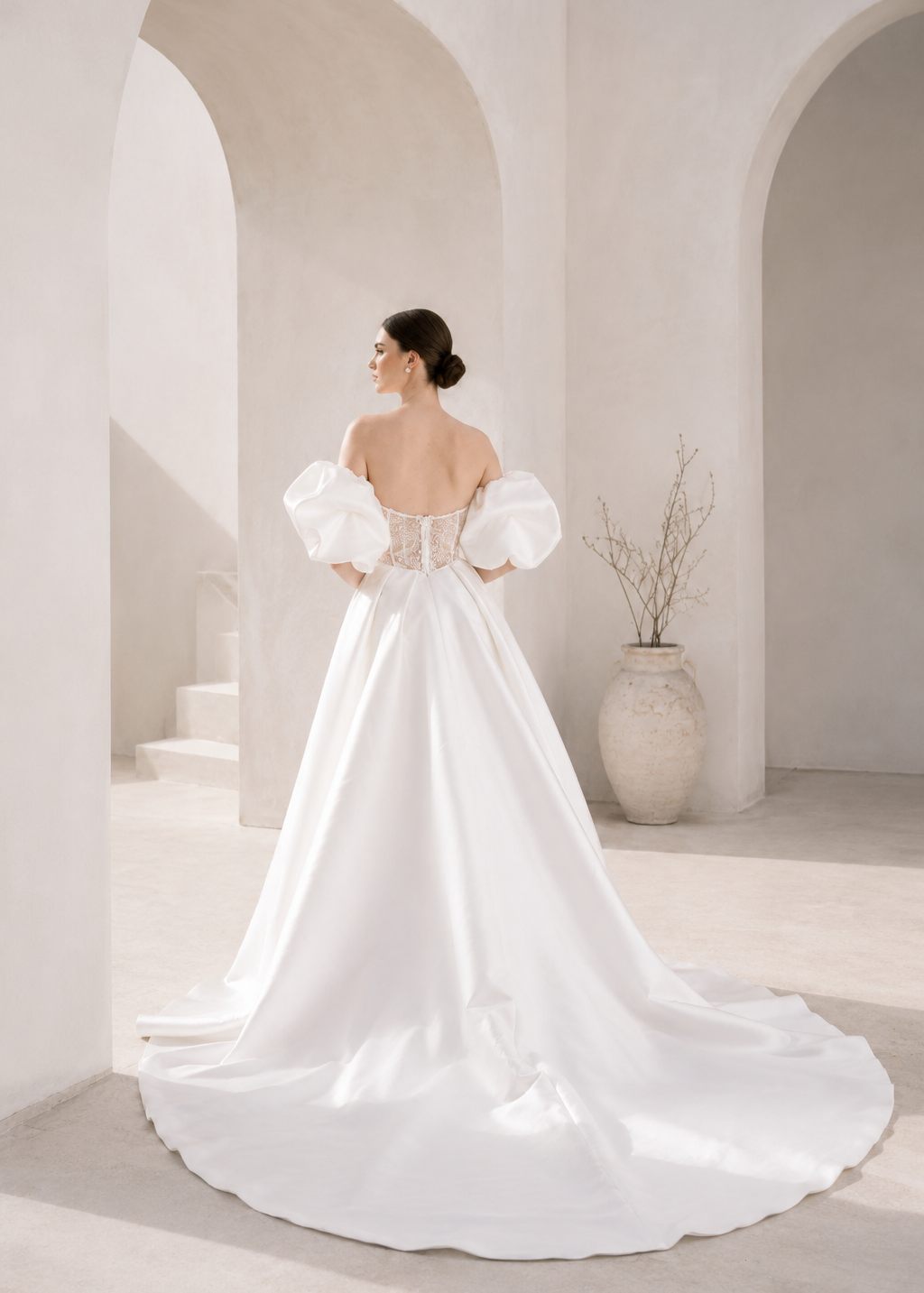 Heston wedding dress back view with lace bodice detail, puff sleeves and full satin skirt with train.