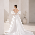 Heston wedding dress back view with lace bodice detail, puff sleeves and full satin skirt with train.