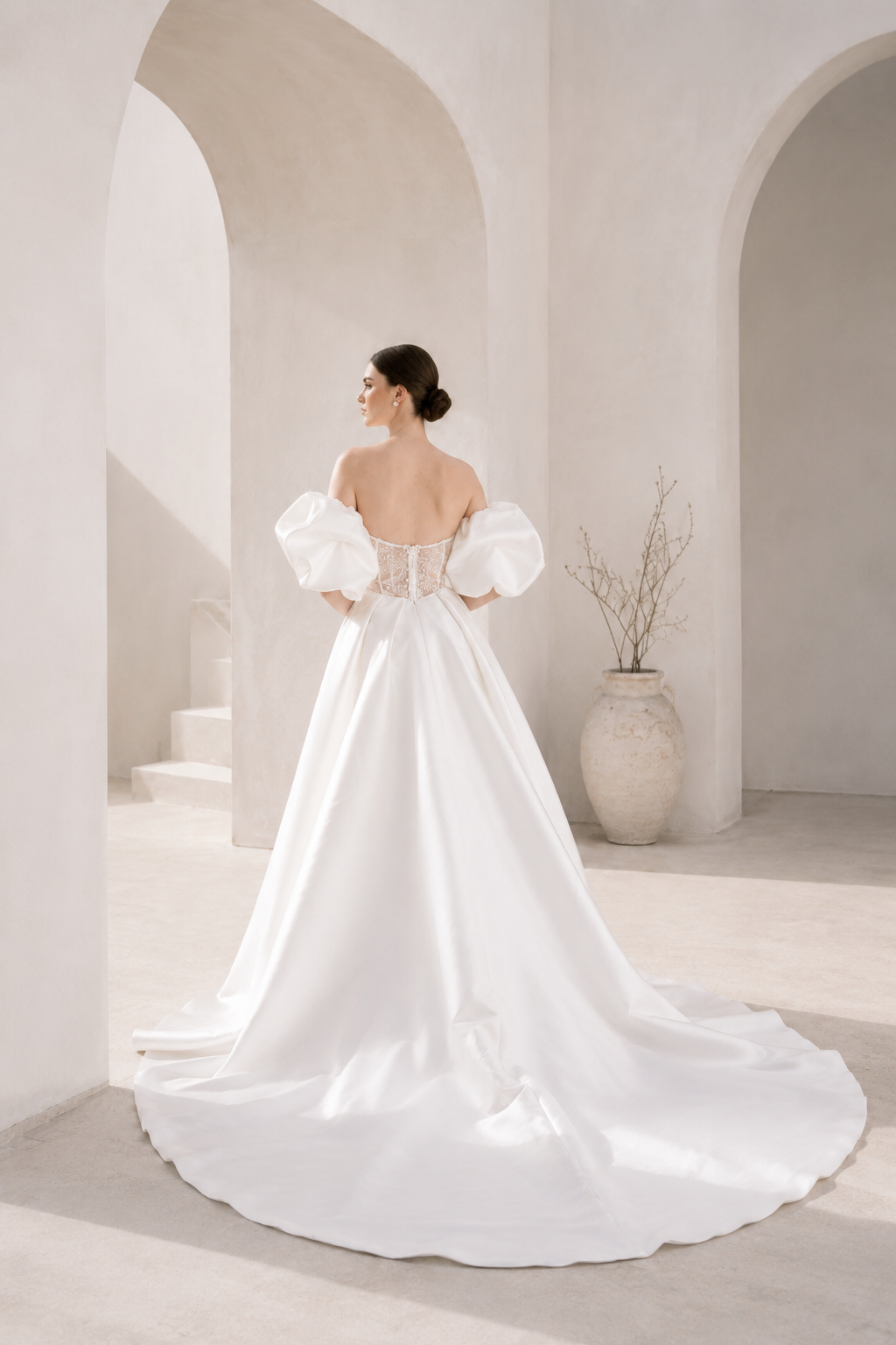 Heston wedding dress back view with lace bodice detail, puff sleeves and full satin skirt with train.