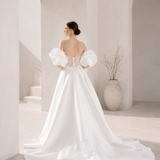 Heston wedding dress back view with lace bodice detail, puff sleeves and full satin skirt with train.