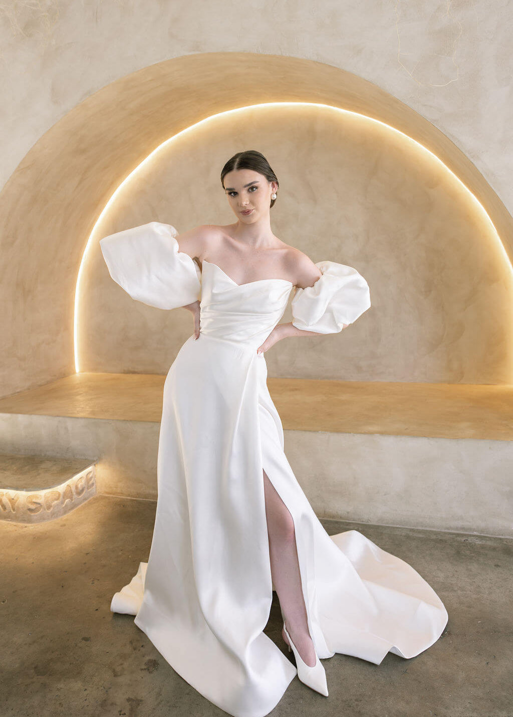 Heston wedding dress with puff sleeves, fitted bodice and satin skirt with leg split.